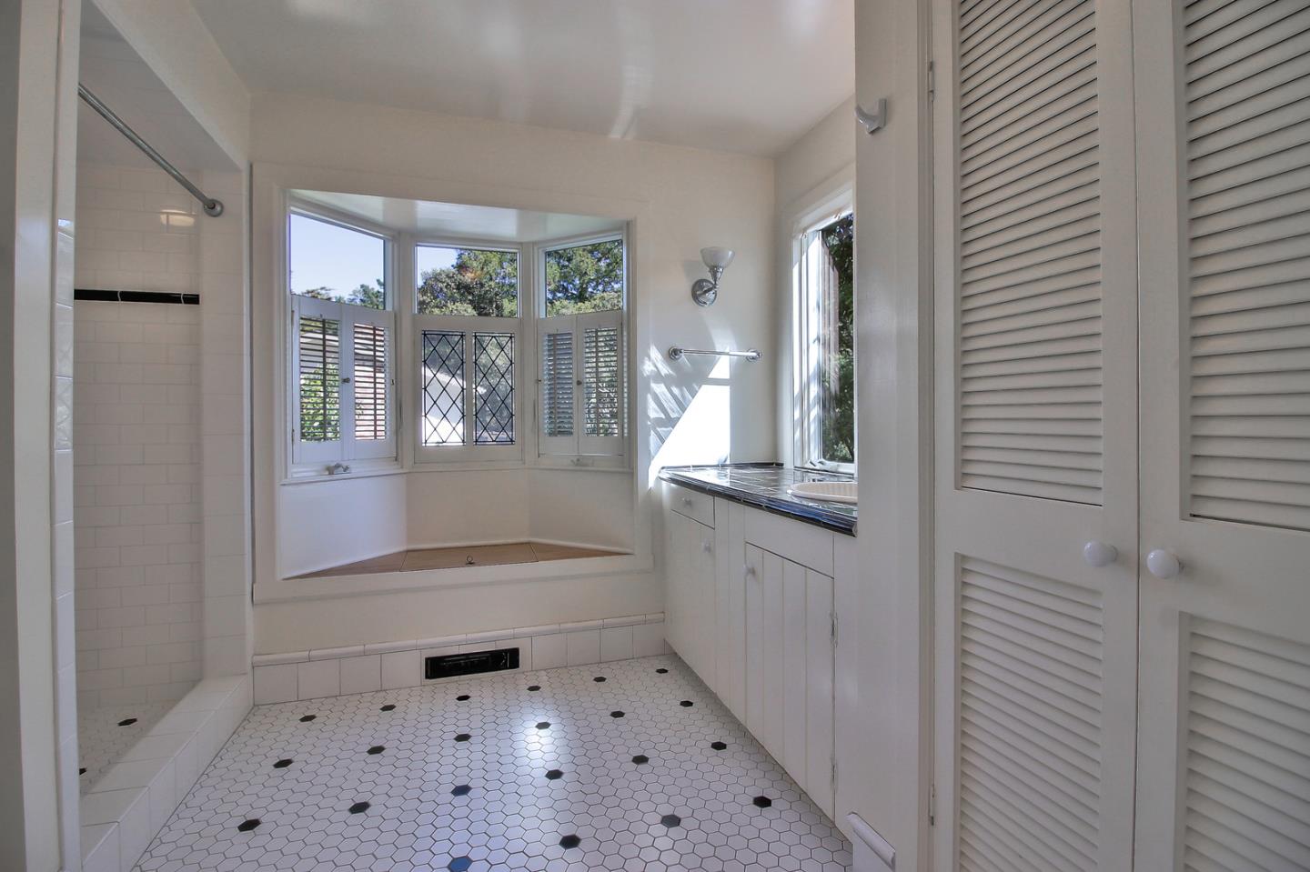 2 San Carlos Street Carmel, CA 93921 - Photo 8 of 22 a bathroom with a glass door shower a sink and a toilet