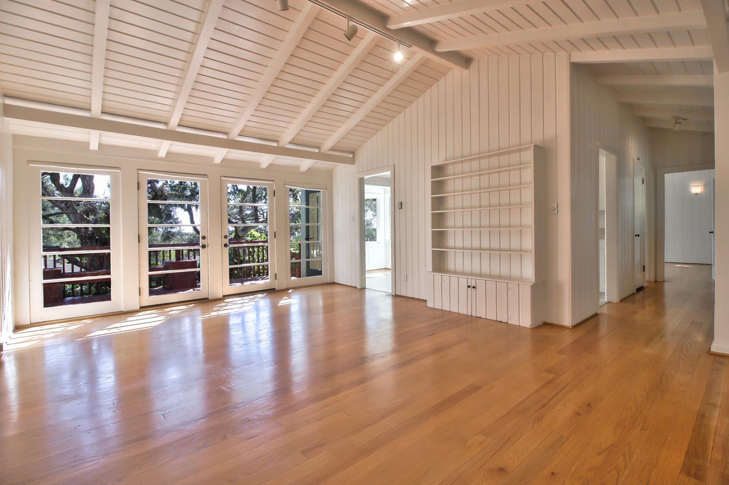 2 San Carlos Street Carmel, CA 93921 - Photo 9 of 22 an empty room with wooden floor and windows