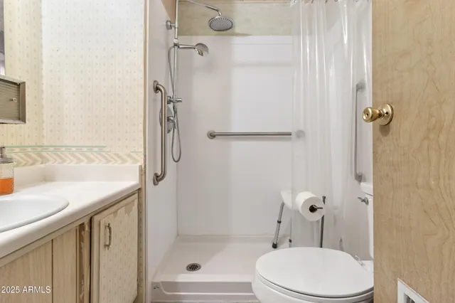 a bathroom with a sink toilet and shower