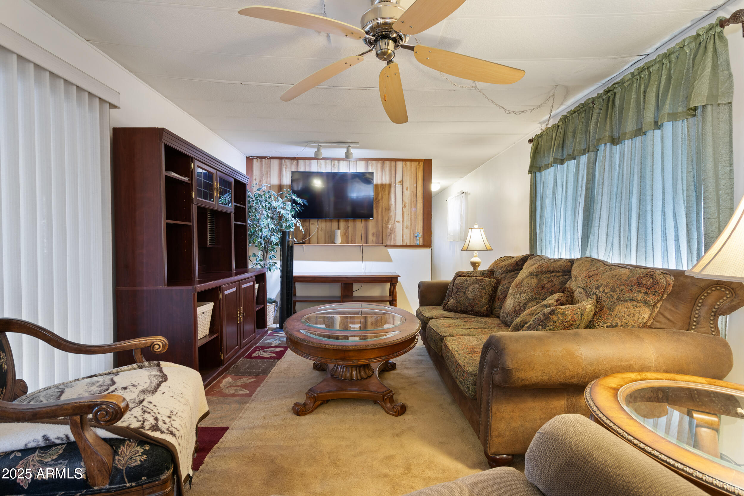 701 South Dobson Road, Unit 16 Mesa, AZ 85202 - Photo 12 of 55 a living room with furniture a ceiling fan and a rug