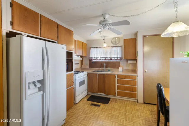 a kitchen with stainless steel appliances a refrigerator and microwave