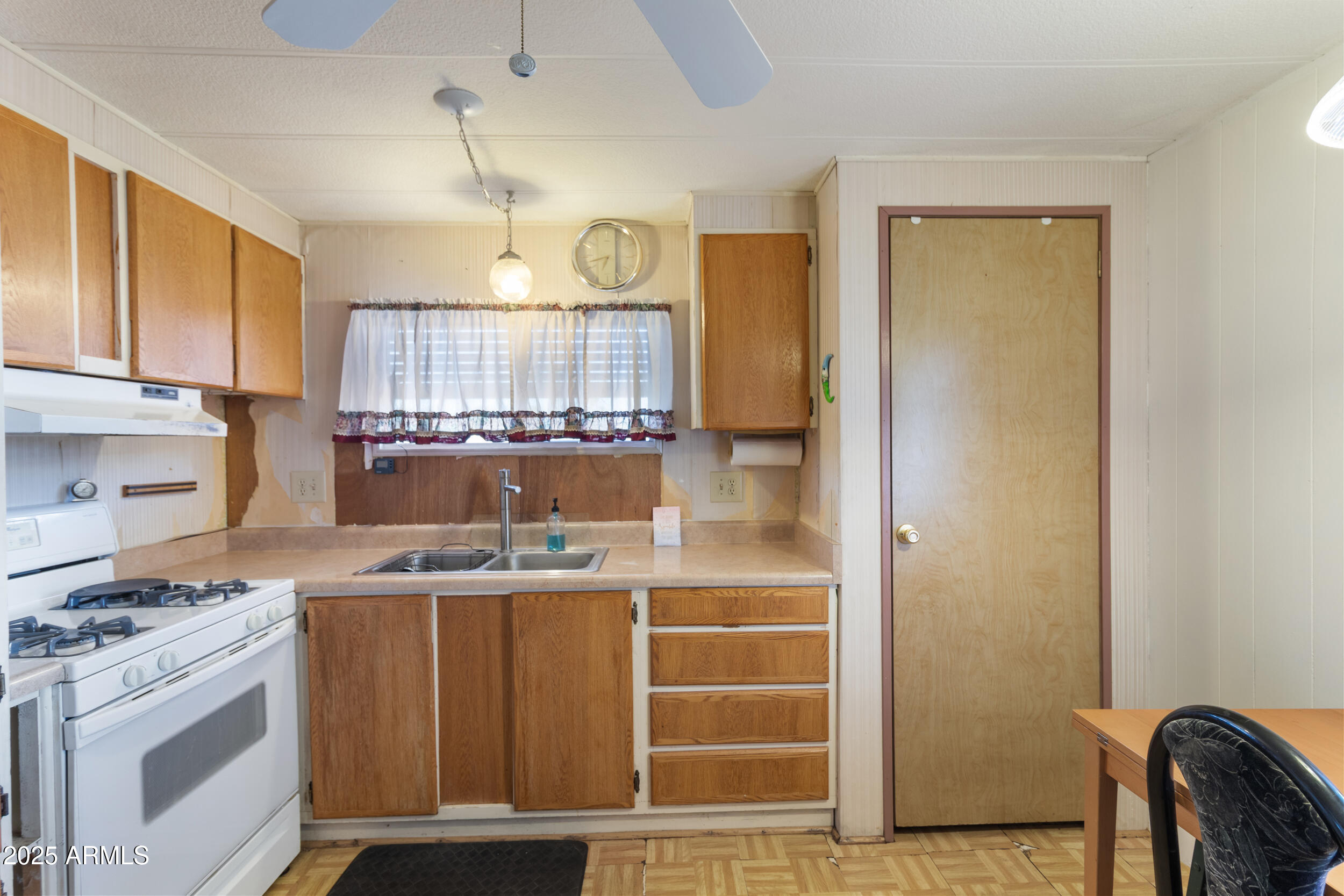 701 South Dobson Road, Unit 16 Mesa, AZ 85202 - Photo 14 of 55 a kitchen with a stove and a refrigerator