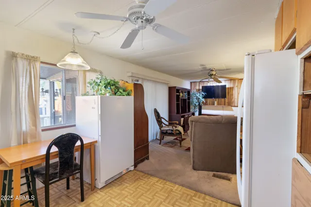 a dining room with furniture a chandelier and a window