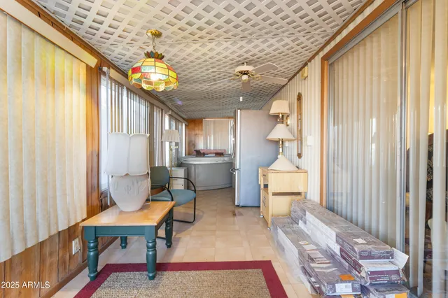 a very nice looking room with many windows and furniture