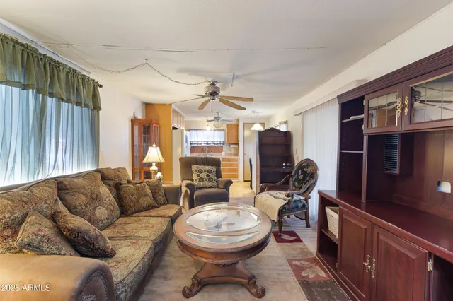 a living room with furniture a dining table and chairs