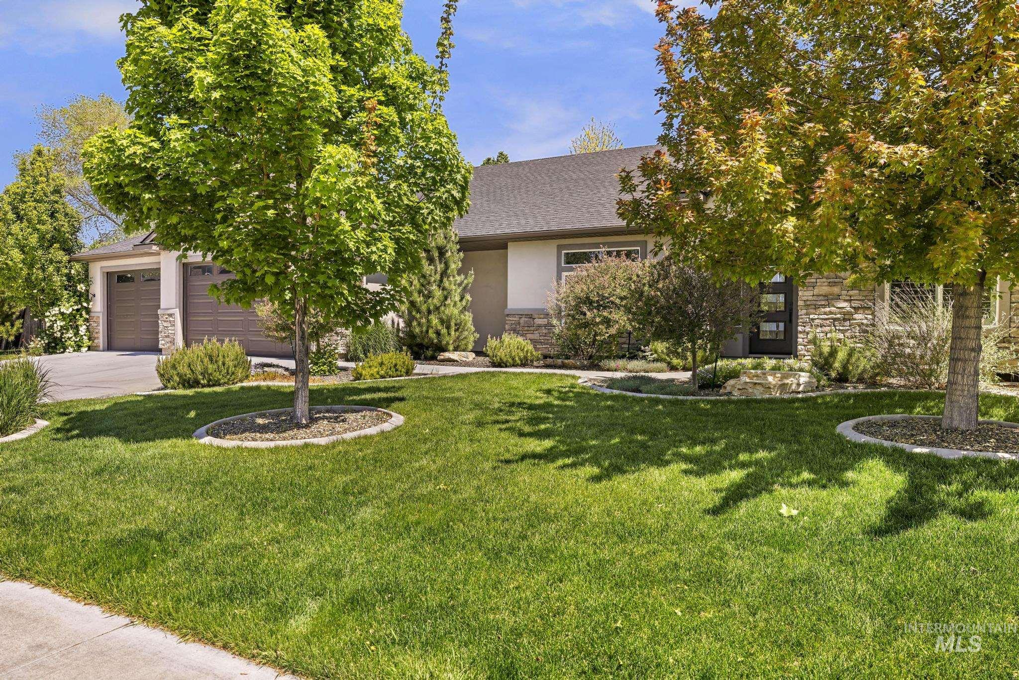 1937 Tamarack Loop Twin Falls, ID 83301 - Photo 3 of 50 Exterior showcasing a manicured front lawn, mature trees, and a concrete driveway