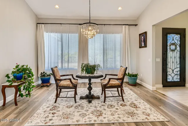 a dining room with furniture a kitchen island a stove and a refrigerator with wooden floor