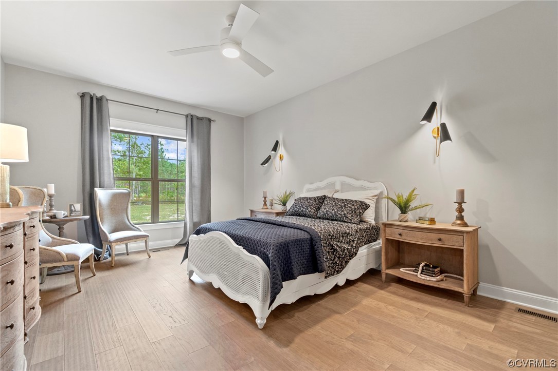11734 Kings Pond Drive Providence Forge, VA 23140 - Photo 13 of 17 a spacious bedroom with a bed and a couch