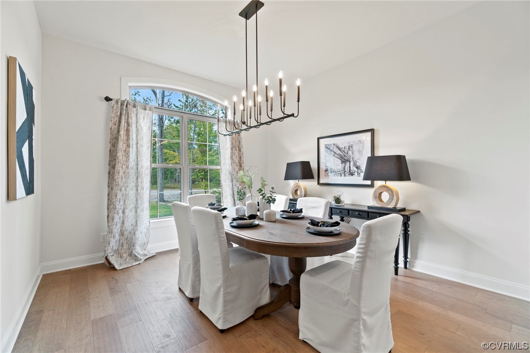 11734 Kings Pond Drive Providence Forge, VA 23140 - Photo 4 of 17 a dining room with furniture a chandelier and wooden floor