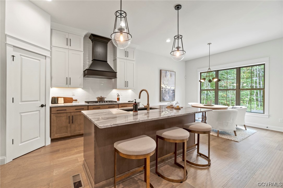 11734 Kings Pond Drive Providence Forge, VA 23140 - Photo 7 of 17 a kitchen with stainless steel appliances granite countertop a sink a stove and chairs with wooden floor