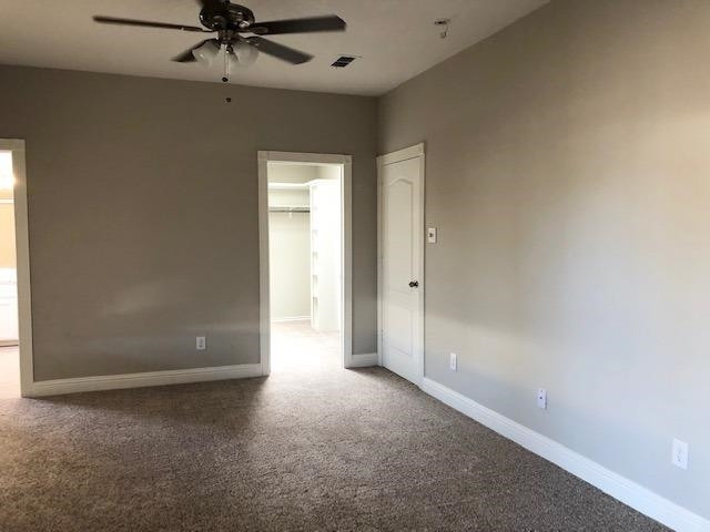 4412 Jarvis Street, Unit 2 Lubbock, TX 79416 - Photo 7 of 16 an empty room with a ceiling fan and a window