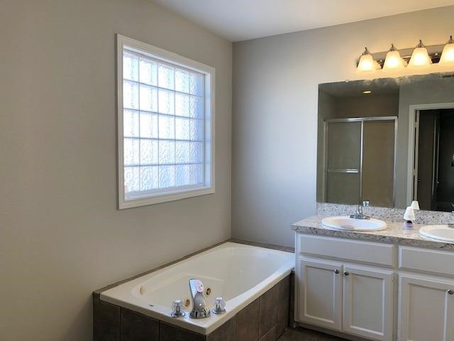 4412 Jarvis Street, Unit 2 Lubbock, TX 79416 - Photo 8 of 16 a bathroom with a sink and a mirror