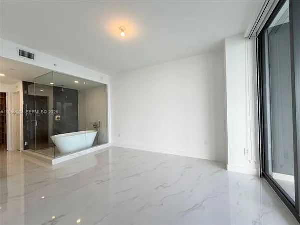 an empty room with large windows