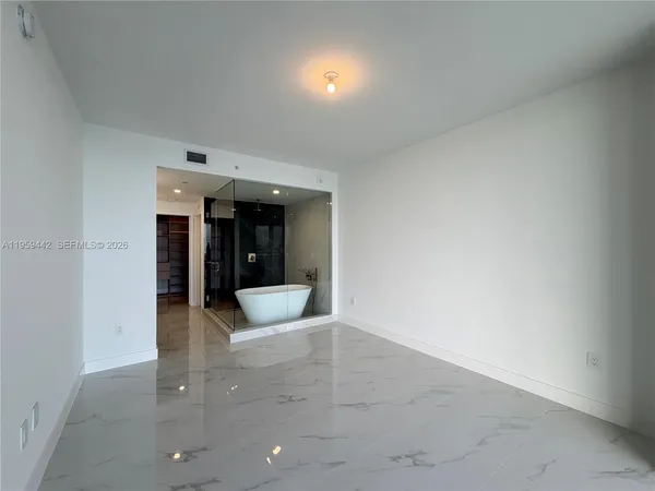 a view of a big room with closet and large windows