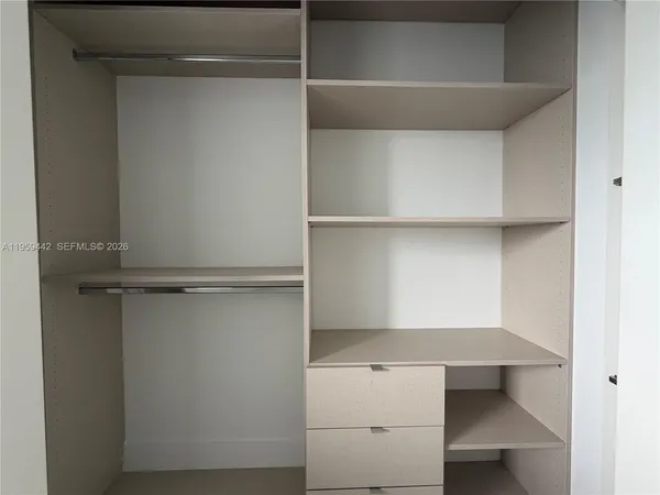 a bathroom with a shower sink and mirror