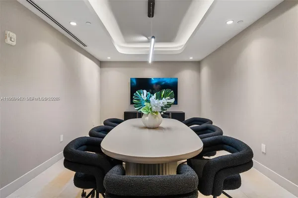 a living room with large window couches and flat screen tv