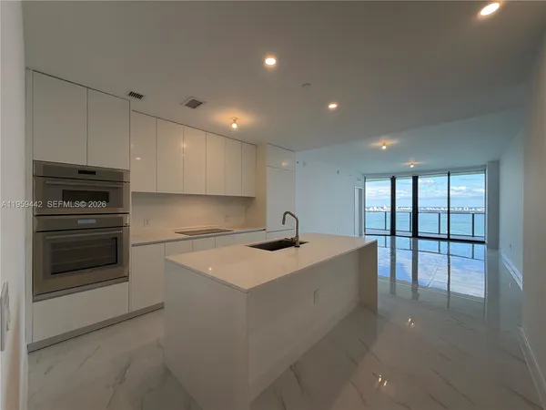 a kitchen with a sink stainless steel appliances and cabinets