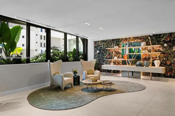 a view of a living room and a floor to ceiling window or fire pit