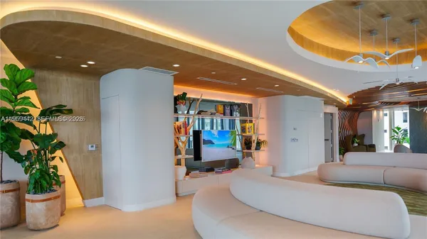 a living room with furniture and a potted plant