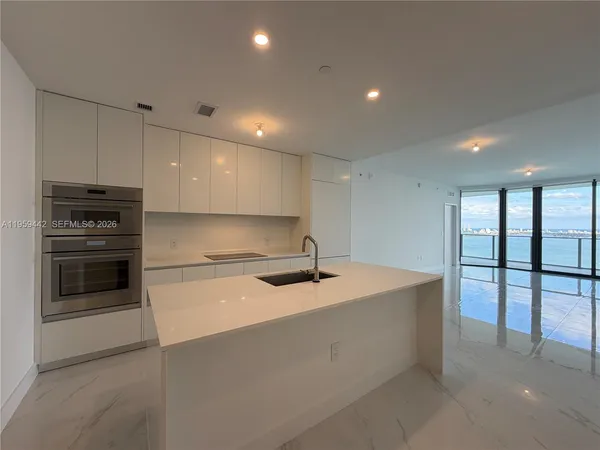 a kitchen with a sink stainless steel appliances and cabinets