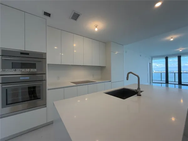 a kitchen with granite countertop a stove and a sink