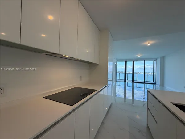 a kitchen that has a sink and a stove