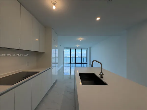 a kitchen with a sink and a stove top oven