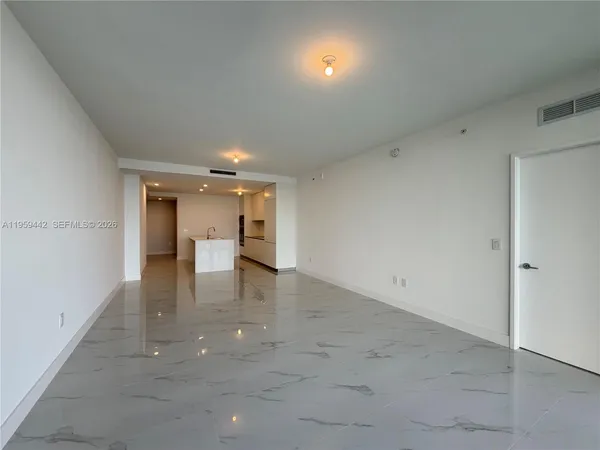 an empty room with closet and windows