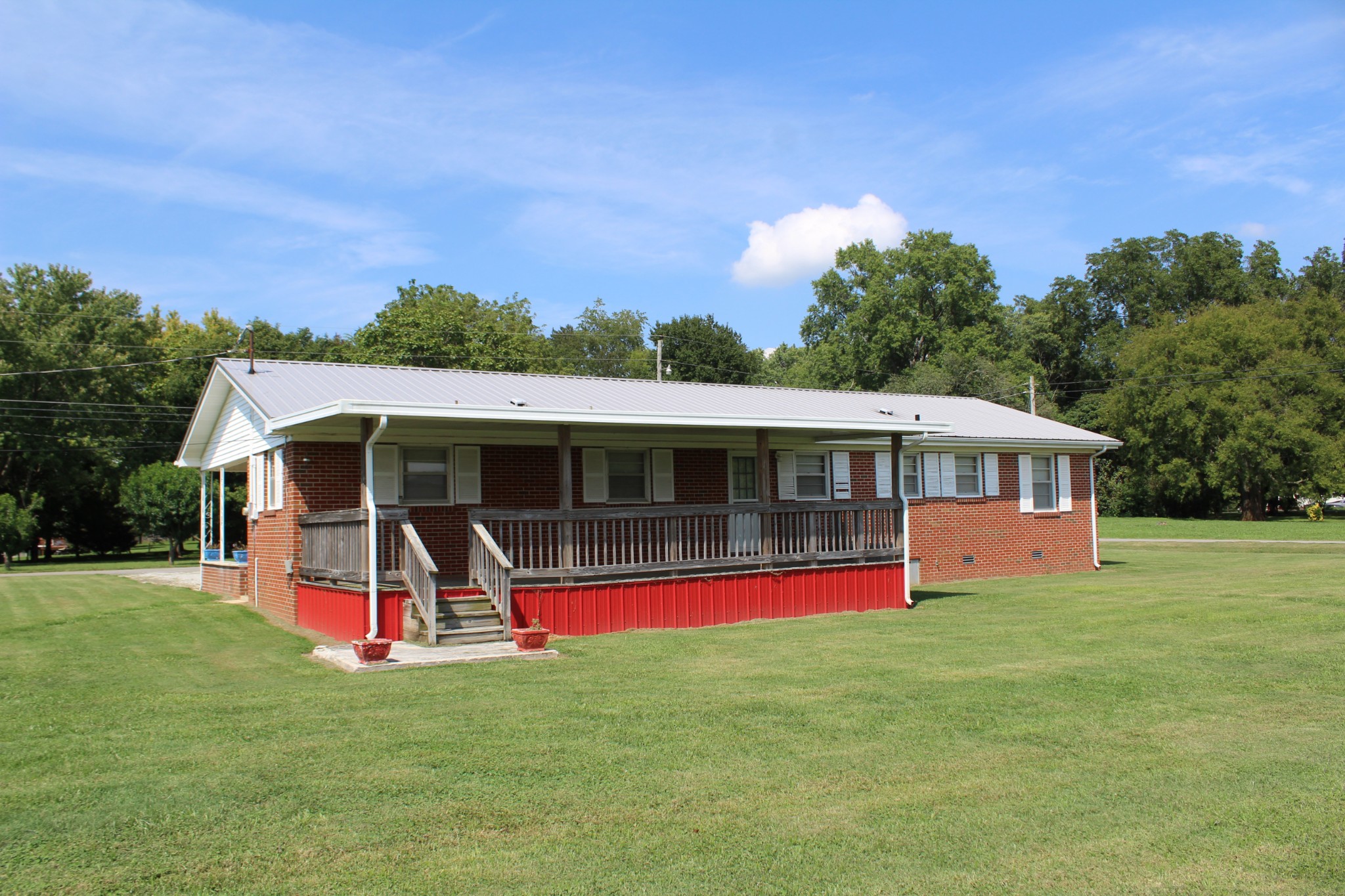 239 Mill Street Viola, TN 37357 - Photo 2 of 27 a view of a house with a big yard and a large tree