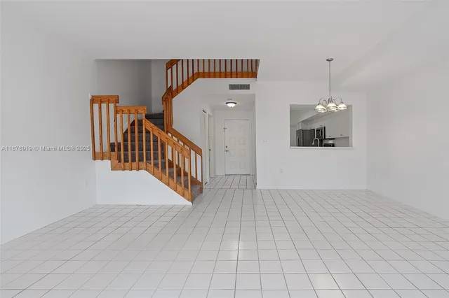 a view of a hallway with stairs