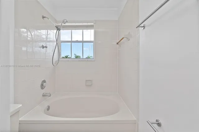 a white bath tub sitting next to a window