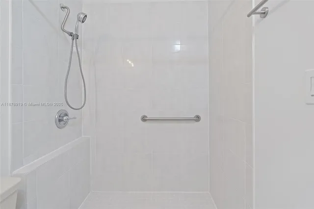 a bathroom with a glass shower door