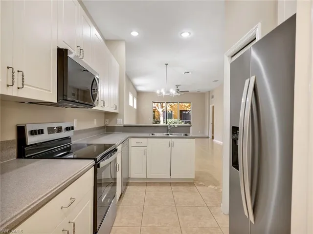a kitchen with stainless steel appliances a refrigerator sink and microwave
