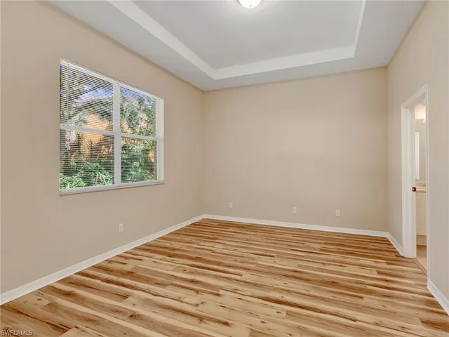 a view of a room with wooden floor and window