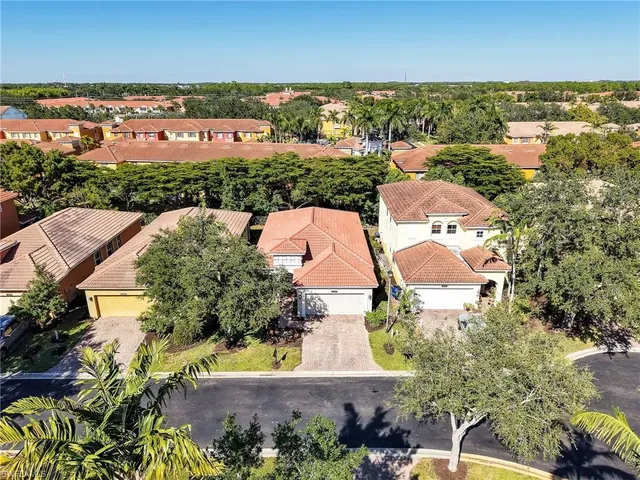 an aerial view of residential houses with outdoor space and river