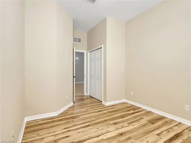 a view of a room with wooden floor