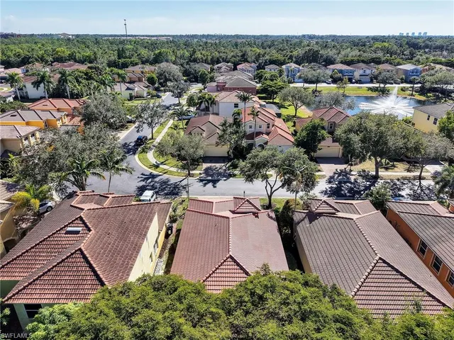 an aerial view of multiple houses with yard