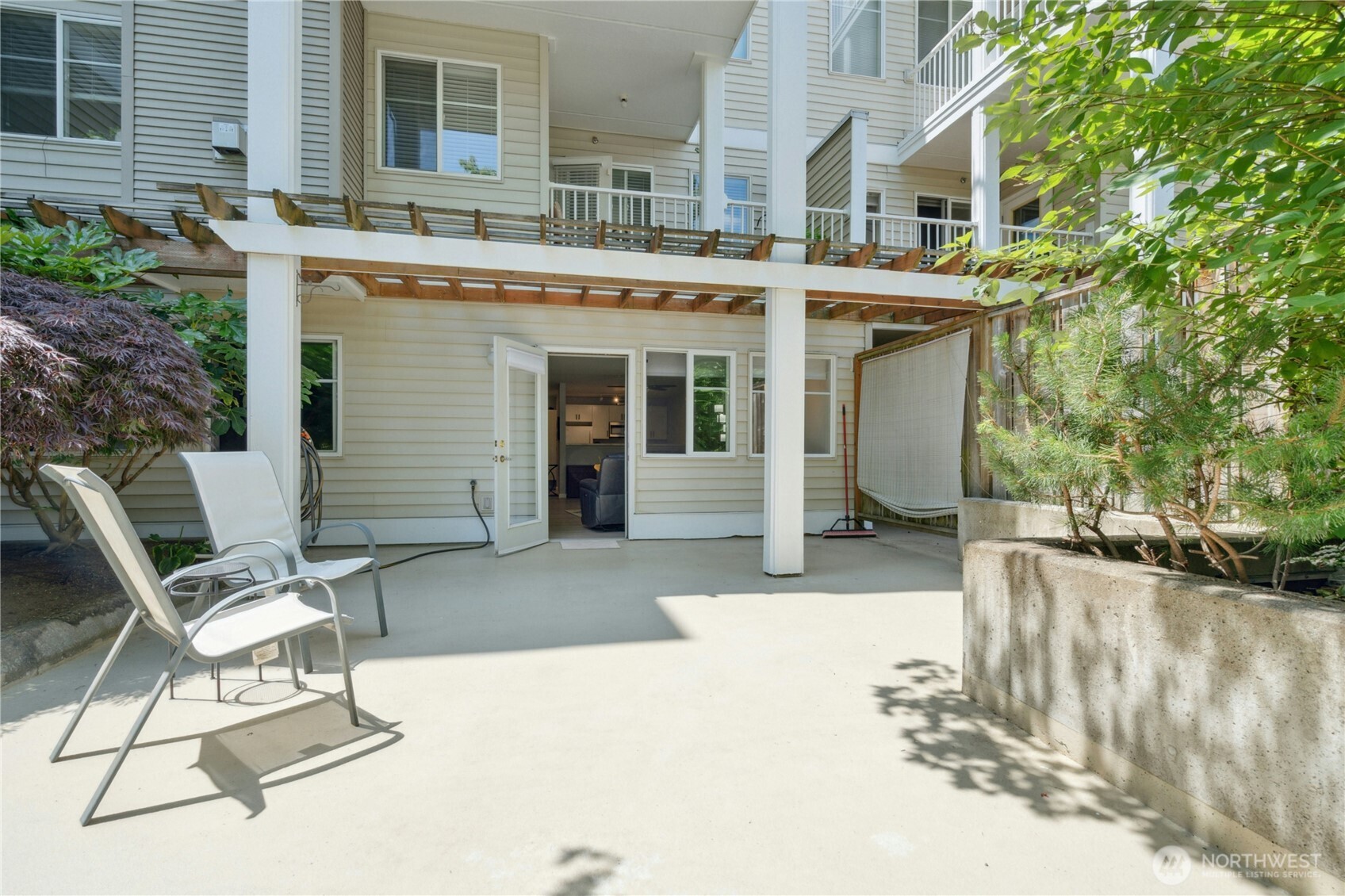 17426 Bothell Way Northeast, Unit A105 Bothell, WA 98011 - Photo 22 of 29 a view of a building with backyard and sitting area