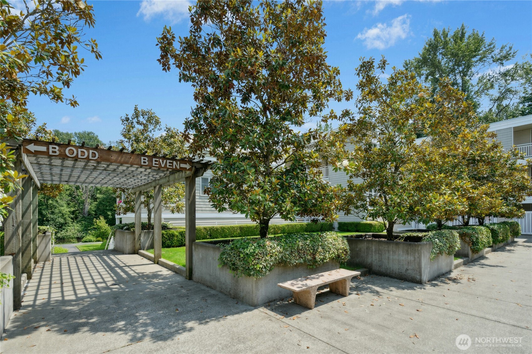 17426 Bothell Way Northeast, Unit A105 Bothell, WA 98011 - Photo 28 of 29 a view of a garden with plants and a bench