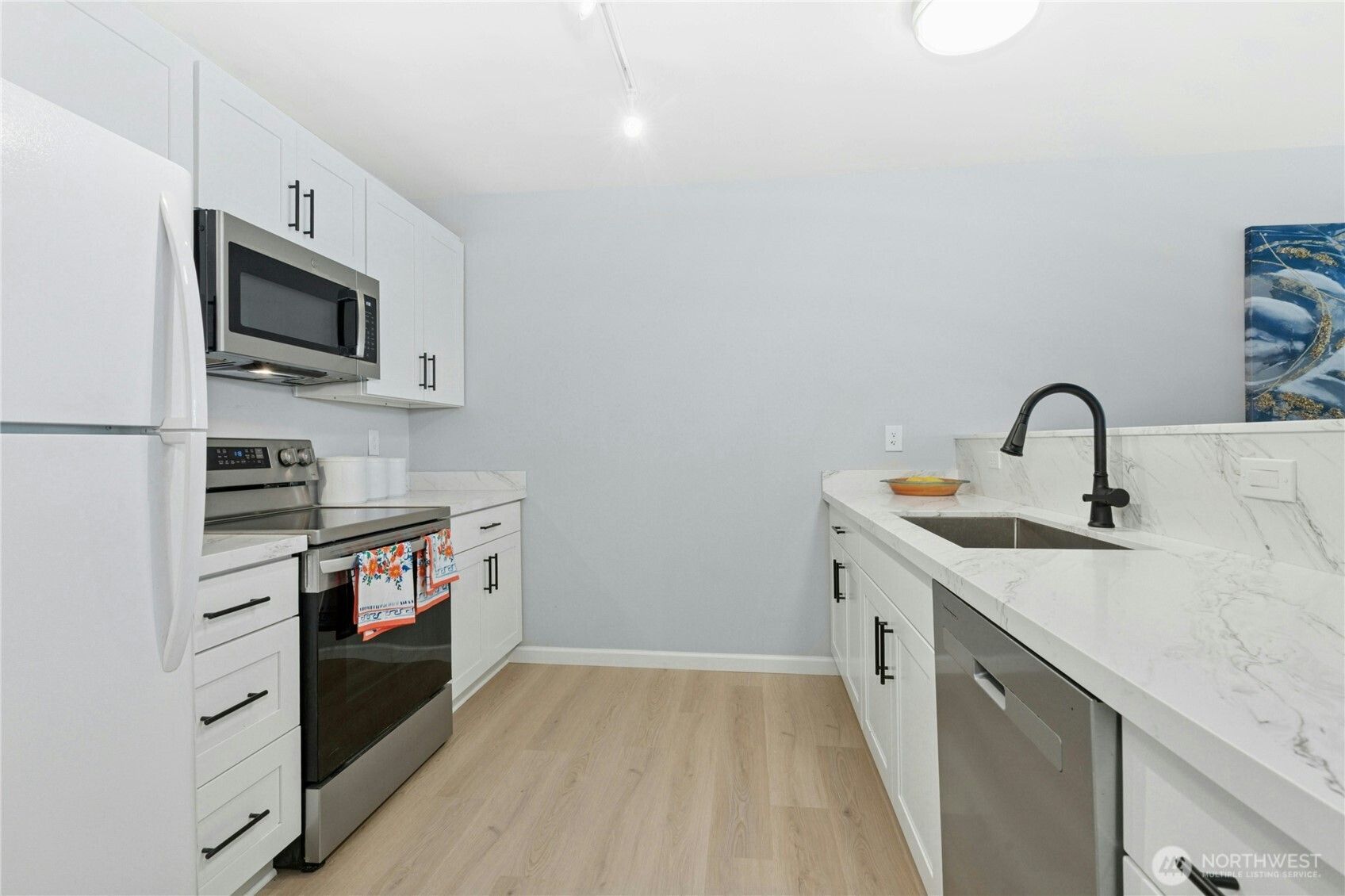 17426 Bothell Way Northeast, Unit A105 Bothell, WA 98011 - Photo 7 of 29 a kitchen with stainless steel appliances granite countertop a sink and a stove top oven