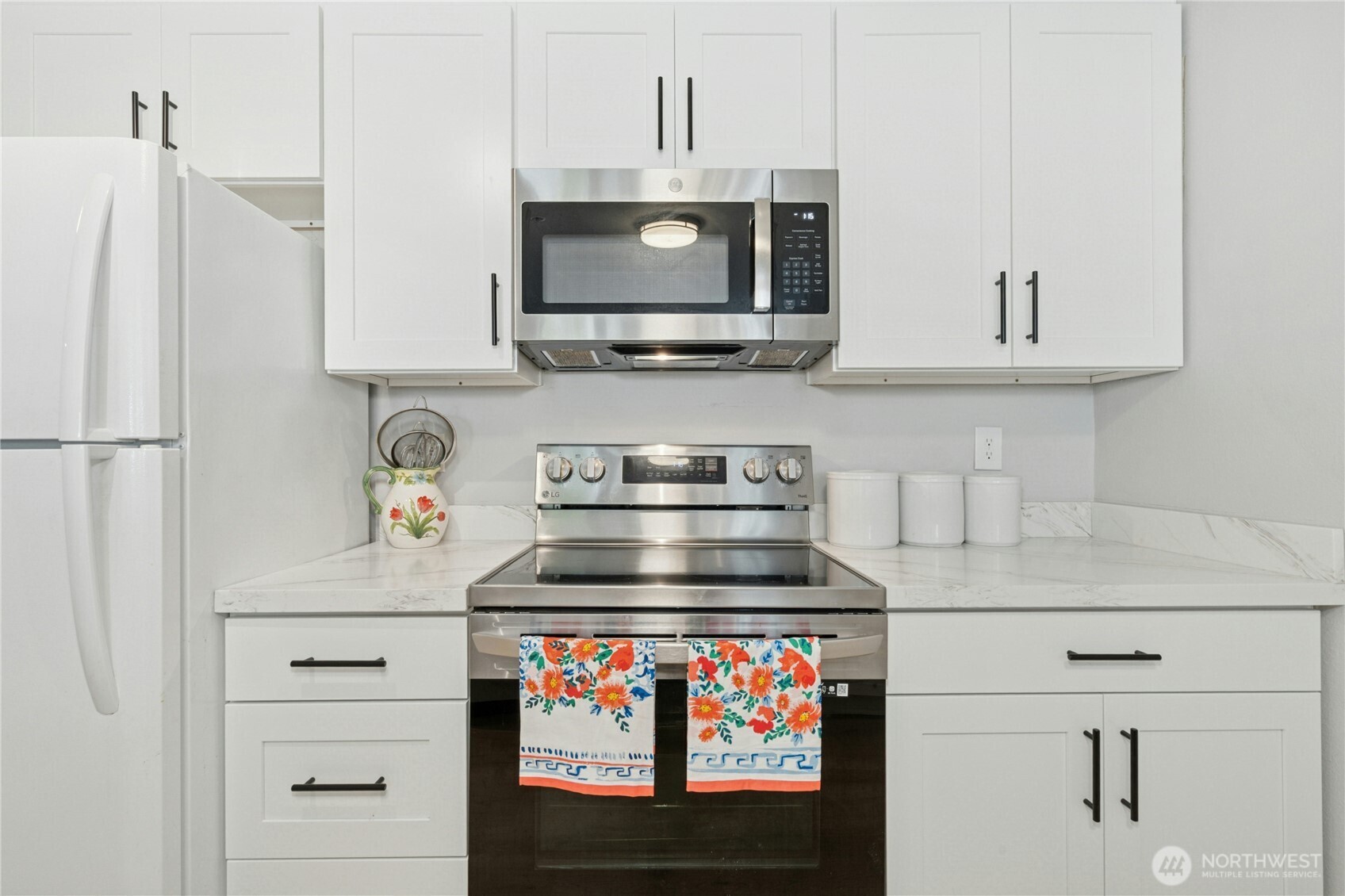 17426 Bothell Way Northeast, Unit A105 Bothell, WA 98011 - Photo 8 of 29 a kitchen with stainless steel appliances granite countertop a stove and a microwave