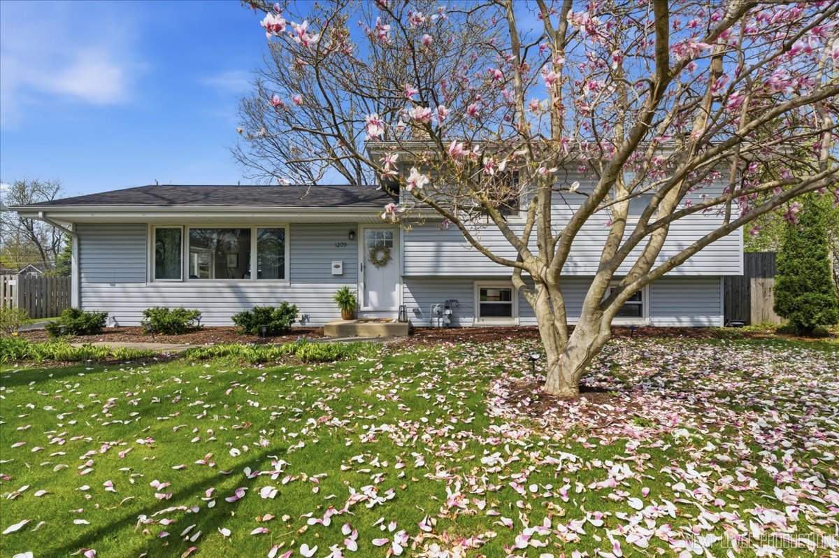 1209 Laurel Lane Naperville, IL 60540 - Photo 1 of 28 a front view of a house with garden