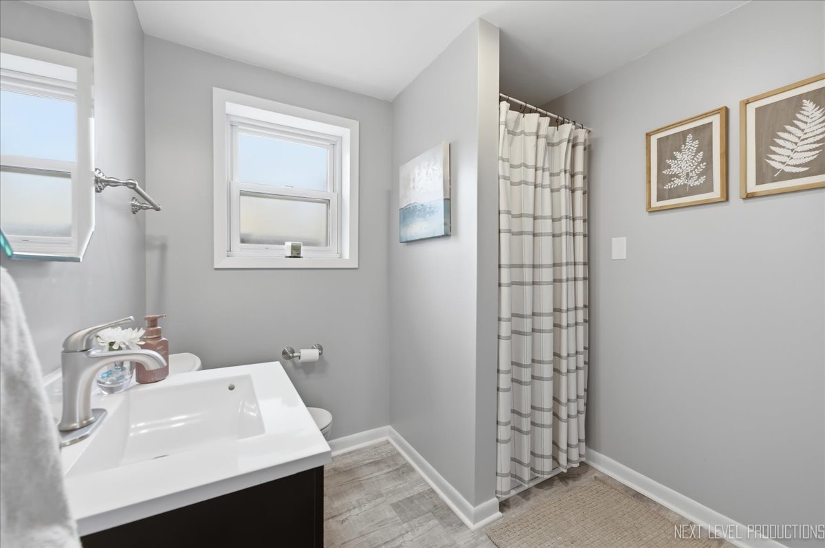 1209 Laurel Lane Naperville, IL 60540 - Photo 15 of 28 a bathroom with a sink a toilet and shower