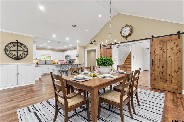 a dining room with furniture and a clock