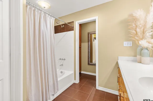 a bathroom with a sink a mirror and a shower