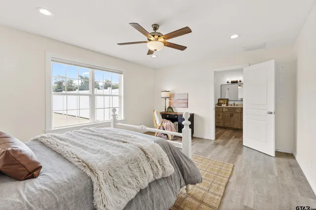 a bed room with a bed and a large window