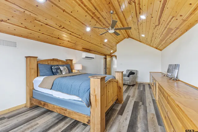 a bed sitting in a bedroom next to a larger window