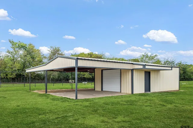 a view of a house with backyard and a garden