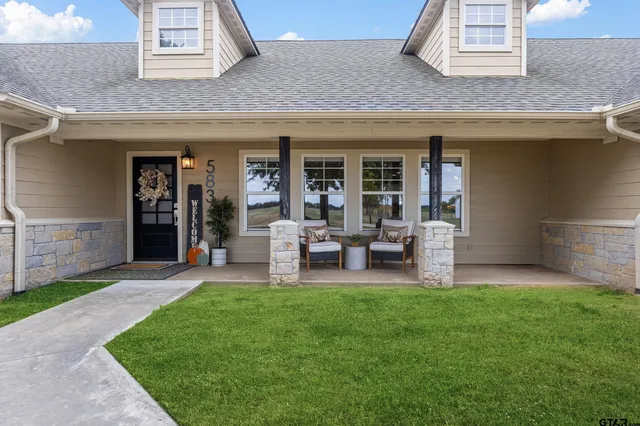 a view of a chair and table in back yard of the house