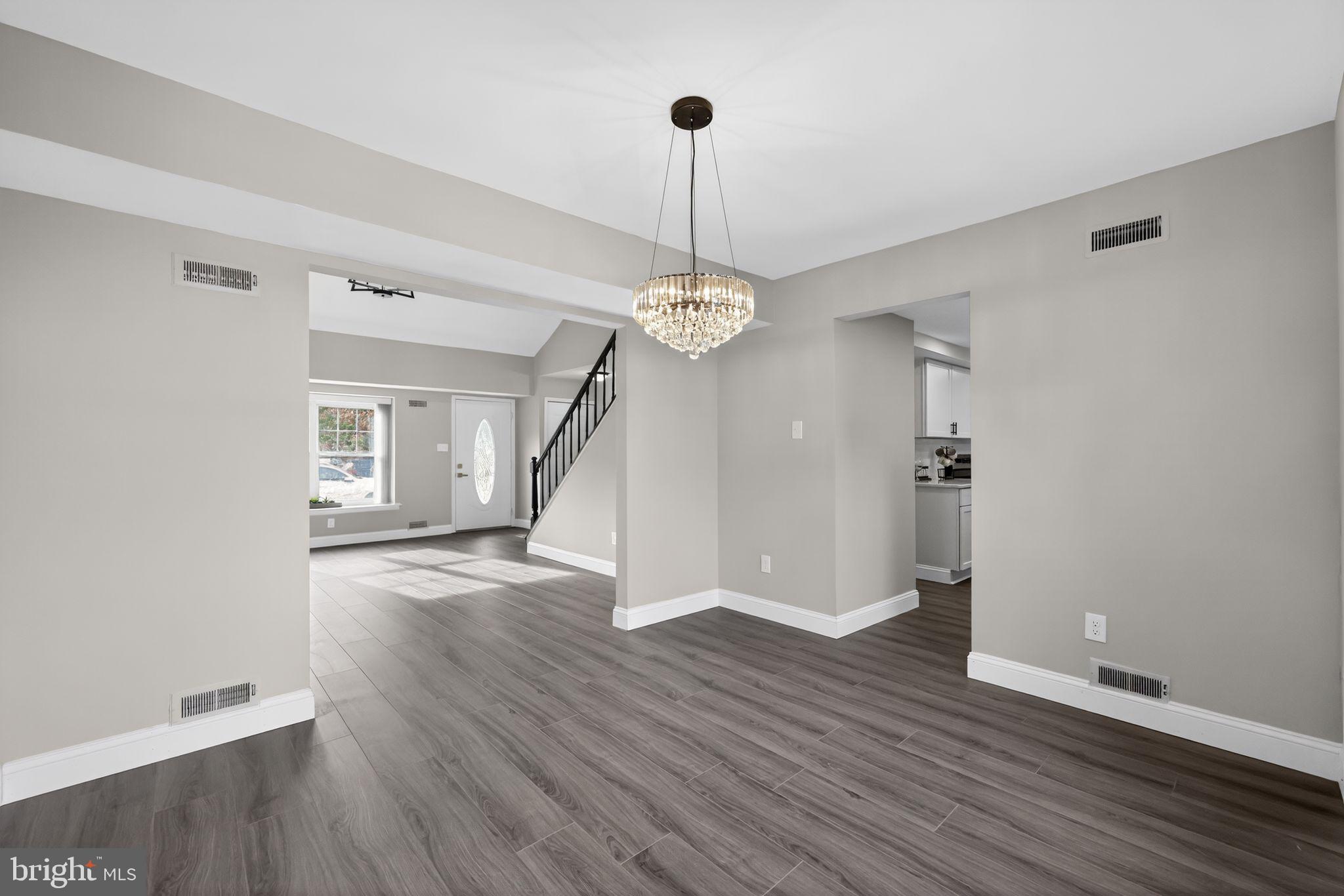 55 Adams Street Swedesboro, NJ 08085 - Photo 12 of 30 a view of a room with wooden floor chandelier and windows
